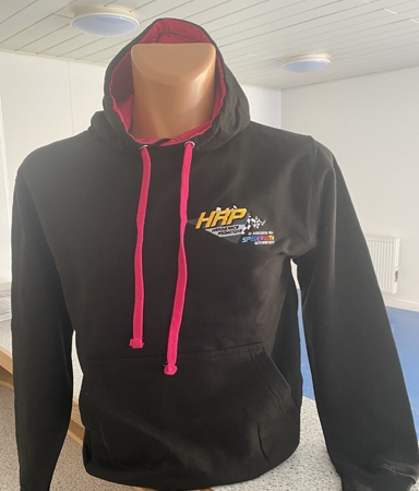 A jet black hooded top, with hot pink hooded lining and toggles